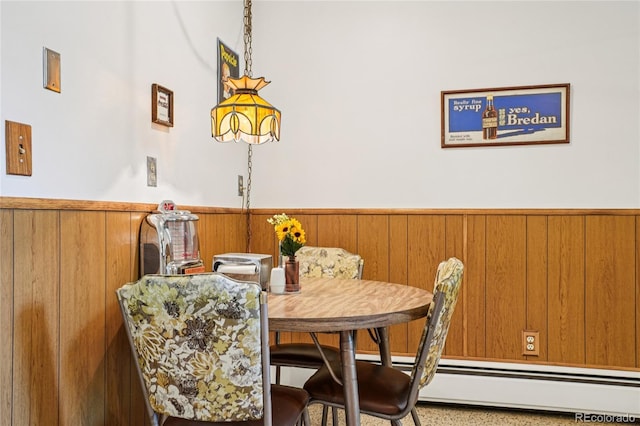 6920 W 47th Pl, Wheat Ridge, CO 80033 - dining area with wainscoting, a baseboard radiator, speckle patterned floor, and wooden walls
