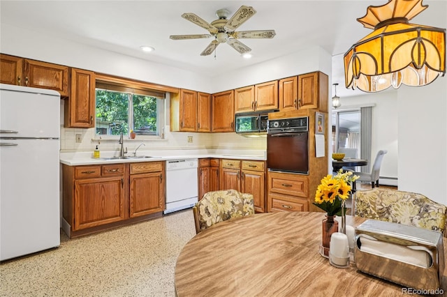 6920 W 47th Pl, Wheat Ridge, CO 80033 - kitchen featuring black appliances, light countertops, a ceiling fan, decorative backsplash, and brown cabinetry