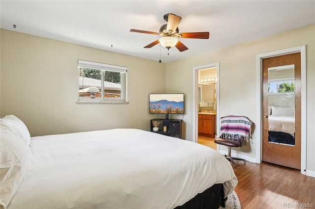 6920 W 47th Pl, Wheat Ridge, CO 80033 - bedroom with light wood finished floors, ensuite bathroom, and ceiling fan