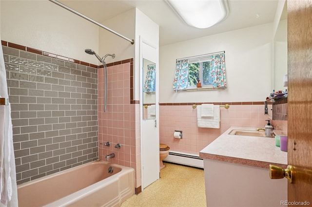 6920 W 47th Pl, Wheat Ridge, CO 80033 - full bathroom with vanity, baseboard heating, shower / tub combo with curtain, tile walls, and a wainscoted wall