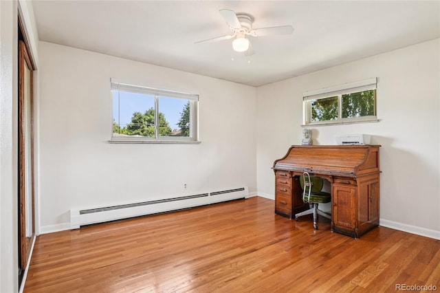 6920 W 47th Pl, Wheat Ridge, CO 80033 - home office featuring plenty of natural light, a baseboard heating unit, light wood finished floors, and ceiling fan