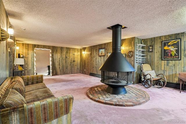 6920 W 47th Pl, Wheat Ridge, CO 80033 - living area featuring carpet floors, a textured ceiling, wooden walls, and a wood stove