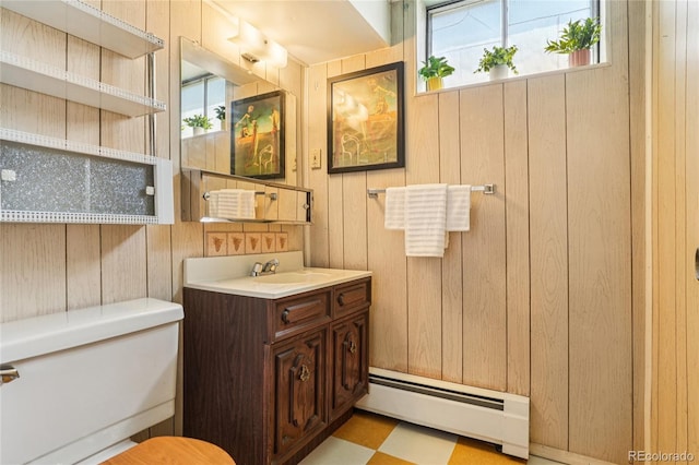 6920 W 47th Pl, Wheat Ridge, CO 80033 - bathroom with a baseboard heating unit, wood walls, and vanity
