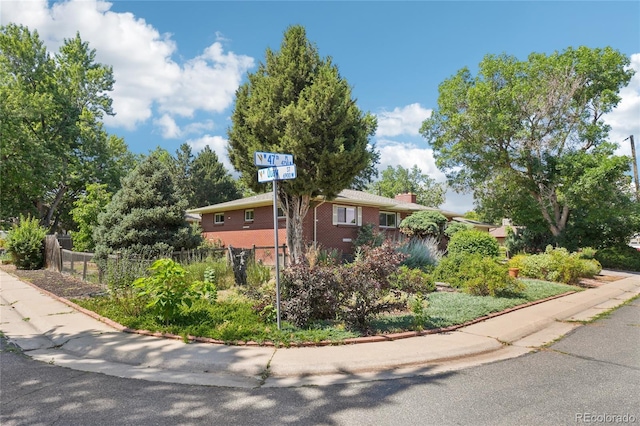 6920 W 47th Pl, Wheat Ridge, CO 80033 - view of side of property with brick siding and a chimney