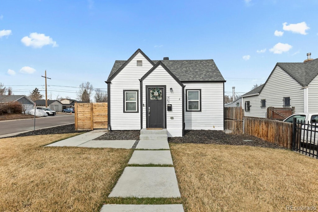 75 S Knox Ct, Denver, CO 80219 - bungalow with a front yard, fence, and roof with shingles