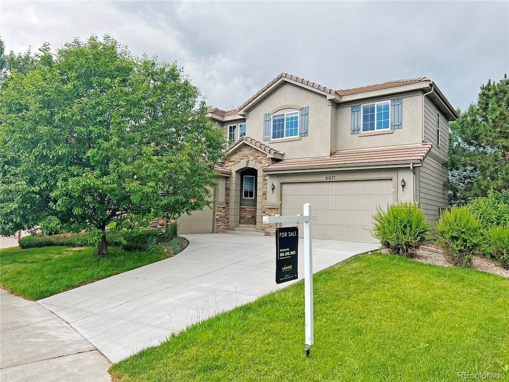 view of front of home featuring a garage and a front lawn