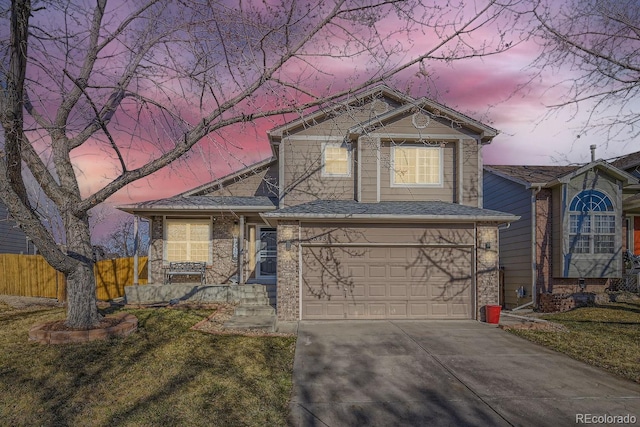 view of front of home with a garage and a yard