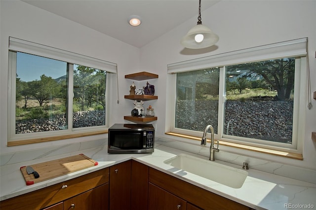 kitchen with backsplash, sink, and hanging light fixtures