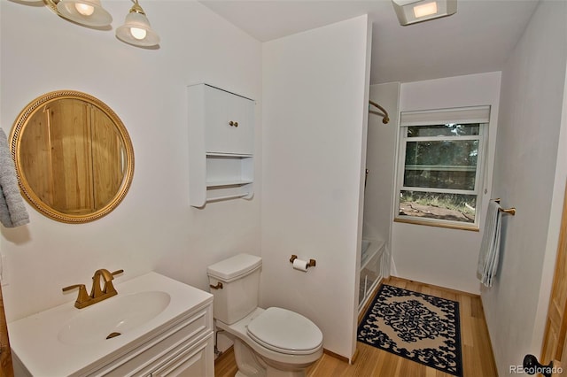 full bathroom featuring vanity, hardwood / wood-style flooring, toilet, and  shower combination