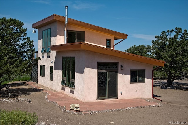 rear view of property featuring a patio