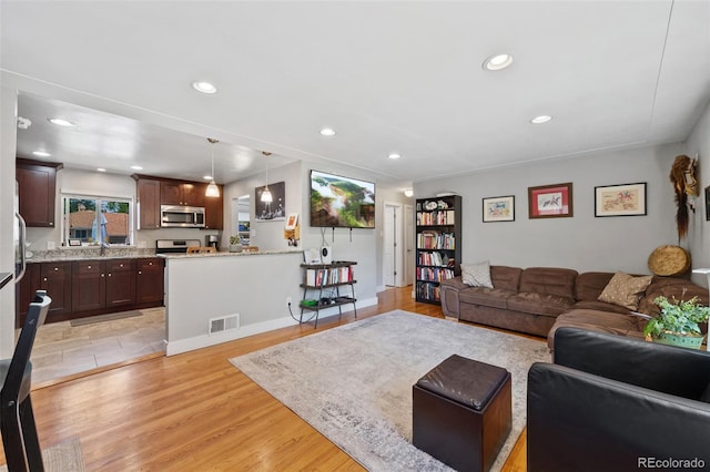 living room with light hardwood / wood-style floors