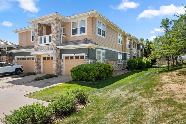 3329 Molly Ln, Broomfield, CO 80023 - view of property with stone siding, a garage, driveway, and a front lawn