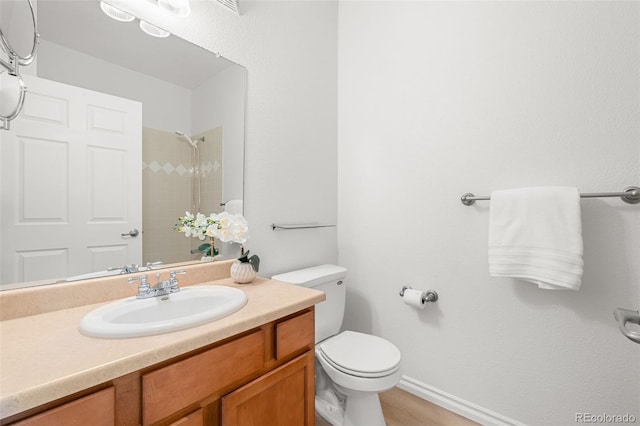 3329 Molly Ln, Broomfield, CO 80023 - bathroom featuring toilet, a shower, vanity, and baseboards