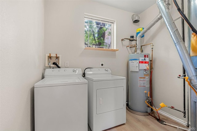 3329 Molly Ln, Broomfield, CO 80023 - washroom featuring gas water heater, washer and clothes dryer, and light wood-type flooring