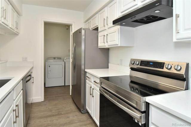 kitchen with stainless steel appliances, light countertops, under cabinet range hood, white cabinetry, and separate washer and dryer