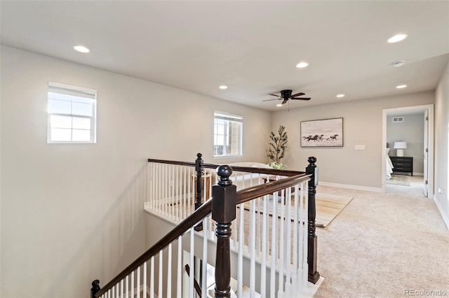 hall with baseboards, light carpet, recessed lighting, and an upstairs landing