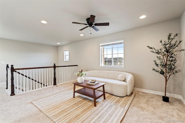 carpeted living area featuring recessed lighting, a ceiling fan, and baseboards