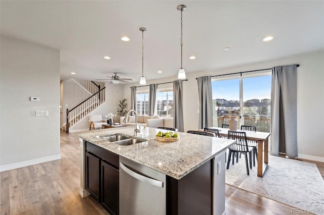 kitchen featuring baseboards, recessed lighting, a sink, light wood-style flooring, and dishwasher