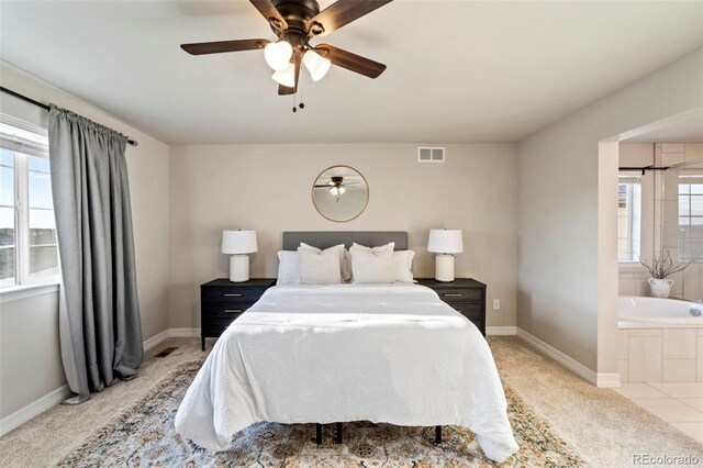 bedroom featuring baseboards, multiple windows, light colored carpet, and visible vents