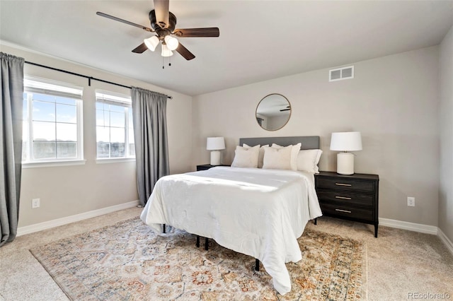 carpeted bedroom featuring baseboards, visible vents, and ceiling fan