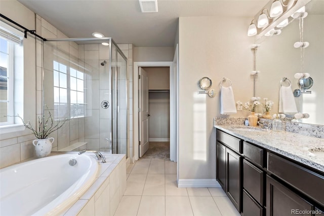 bathroom featuring a spacious closet, a stall shower, a garden tub, and visible vents