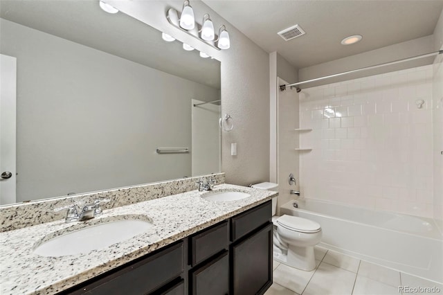 full bathroom with a sink, tile patterned floors, toilet, and double vanity