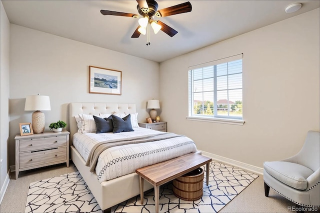 bedroom with baseboards, light colored carpet, and ceiling fan