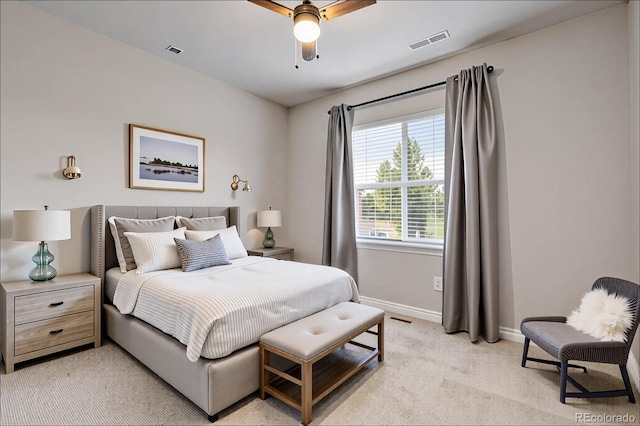 bedroom featuring light colored carpet, baseboards, visible vents, and ceiling fan
