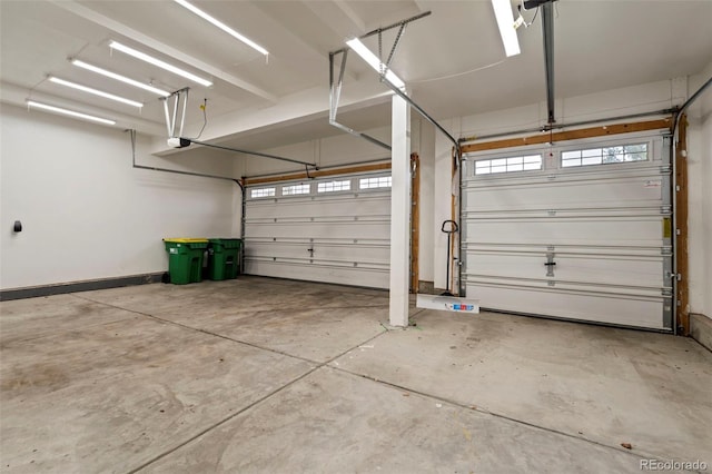 garage with baseboards and a garage door opener