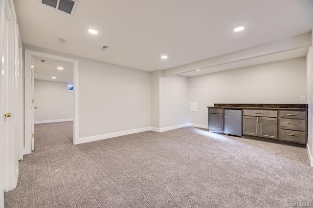 interior space with bar area and light carpet