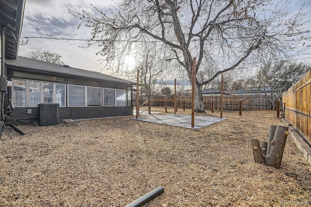 view of yard featuring central AC unit and a patio area