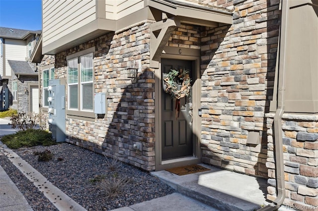 property entrance with stone siding