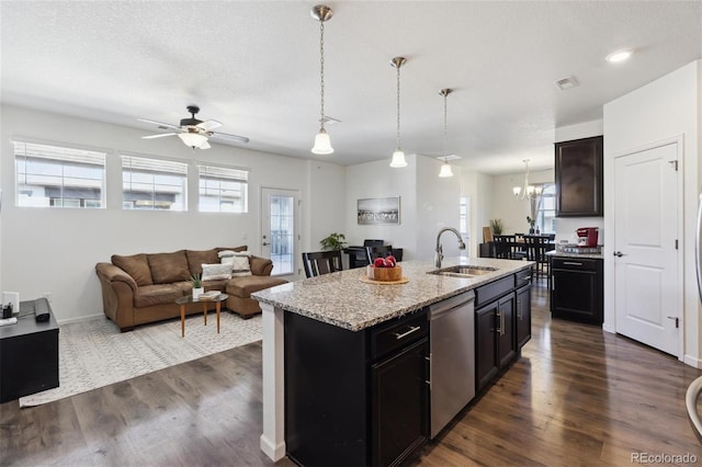 kitchen with dark wood-type flooring, visible vents, a sink, and stainless steel dishwasher