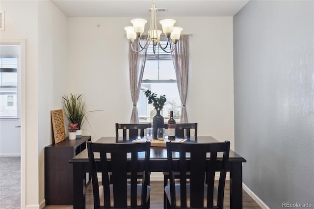 dining space with a healthy amount of sunlight, an inviting chandelier, visible vents, and baseboards