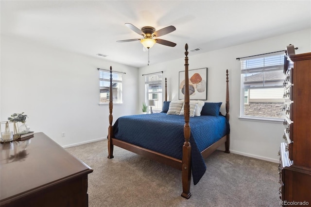 carpeted bedroom featuring ceiling fan, visible vents, and baseboards