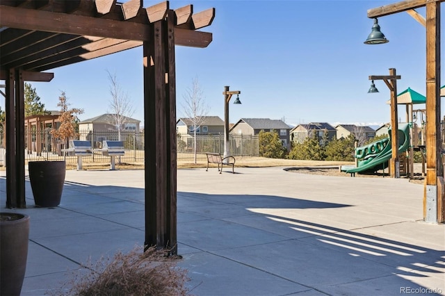 view of patio / terrace with a residential view, playground community, fence, and a pergola