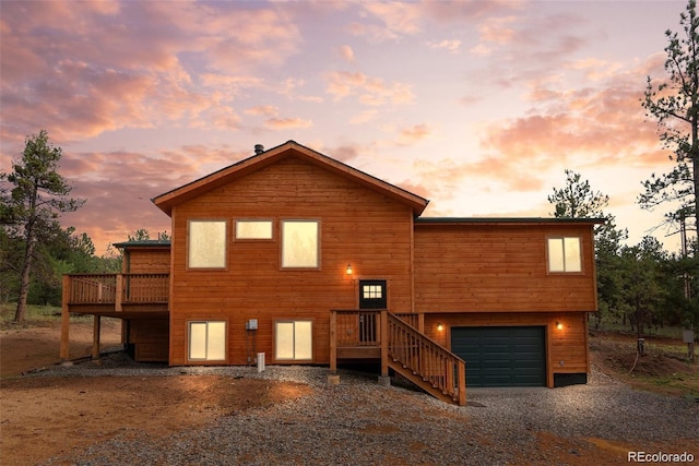 view of front of house with a wooden deck and a garage