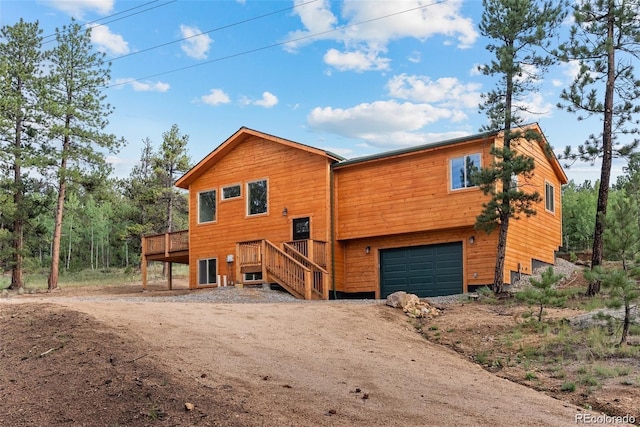 view of front of property with a wooden deck and a garage