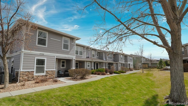 exterior space featuring a front lawn and cooling unit