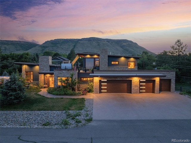 modern home with a mountain view and a garage