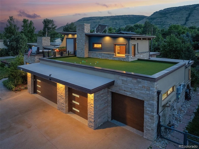 contemporary house featuring a lawn and a mountain view