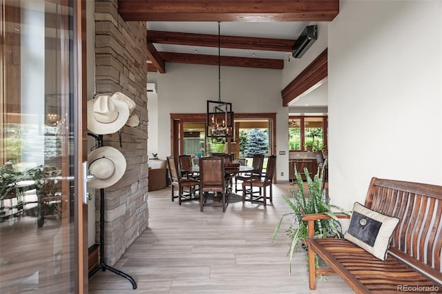 dining area featuring beam ceiling, an AC wall unit, and a notable chandelier