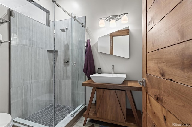 bathroom with vanity and a shower with door