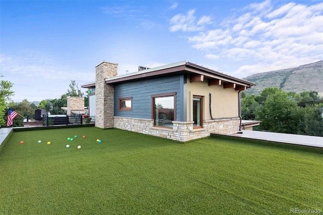 back of house with a mountain view