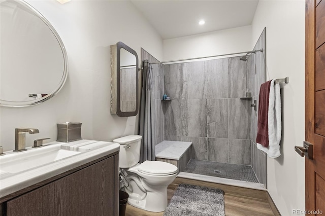 bathroom with a shower with curtain, hardwood / wood-style floors, vanity, and toilet