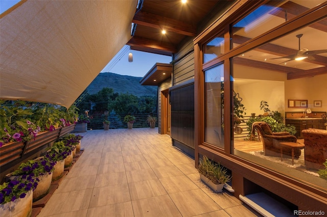 view of patio featuring a mountain view and ceiling fan