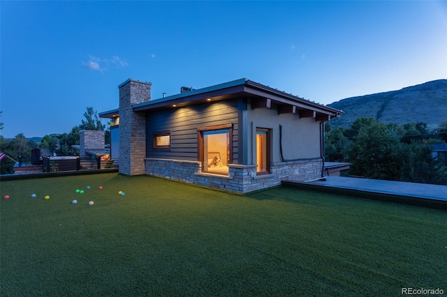 property exterior at dusk with a mountain view