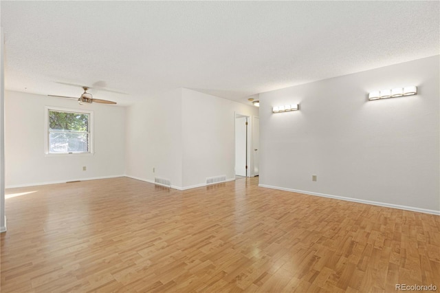 unfurnished room featuring ceiling fan, a textured ceiling, and light wood-type flooring