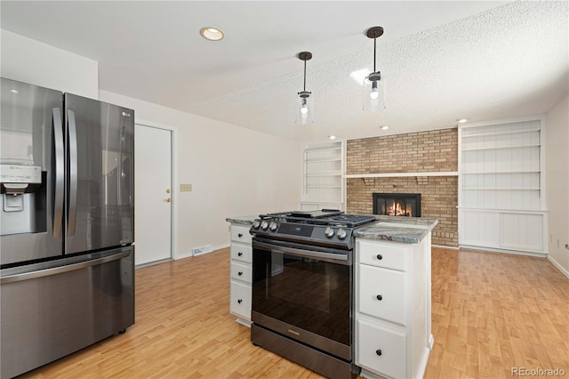 kitchen with stainless steel fridge with ice dispenser, white cabinetry, black gas stove, a textured ceiling, and light wood-type flooring