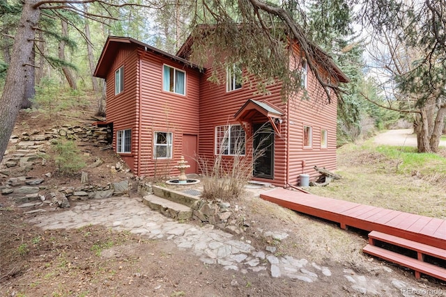 exterior space featuring faux log siding